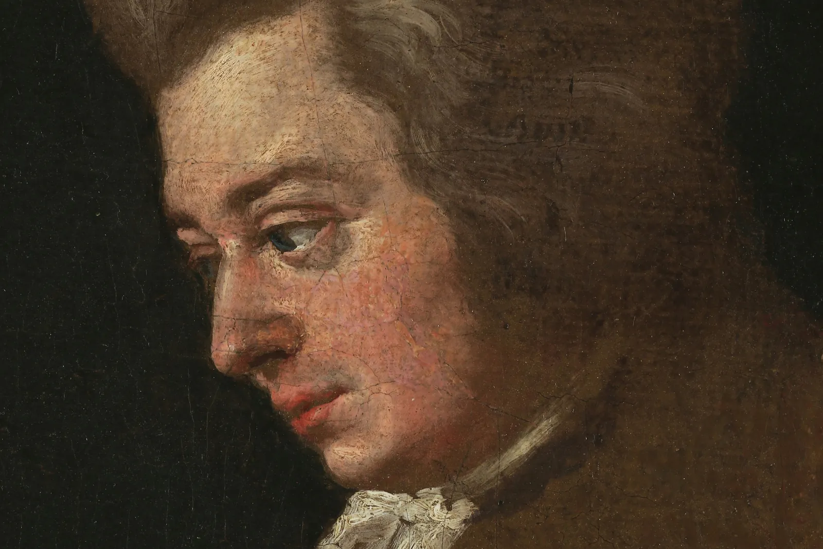 Unfinished portrait of Wolfgang Amadeus Mozart painted by Joseph Lange, his face in profile against a dark ground