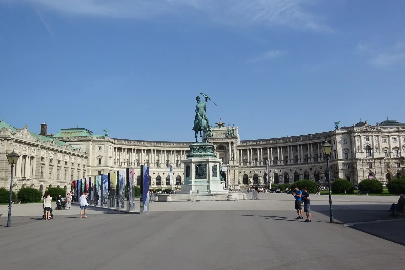 The curved Neue Burg wing of the Hofburg seen across Heldenplatz, with an equestrian statue in front